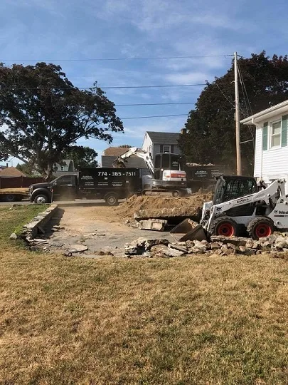 Skid steer working on a yard demolition and regrade