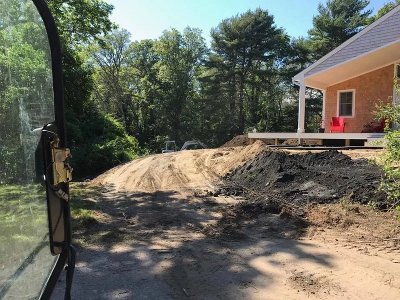 Site cleared and graded beside a new home