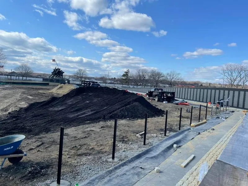 Mound of topsoil beside a new fence line