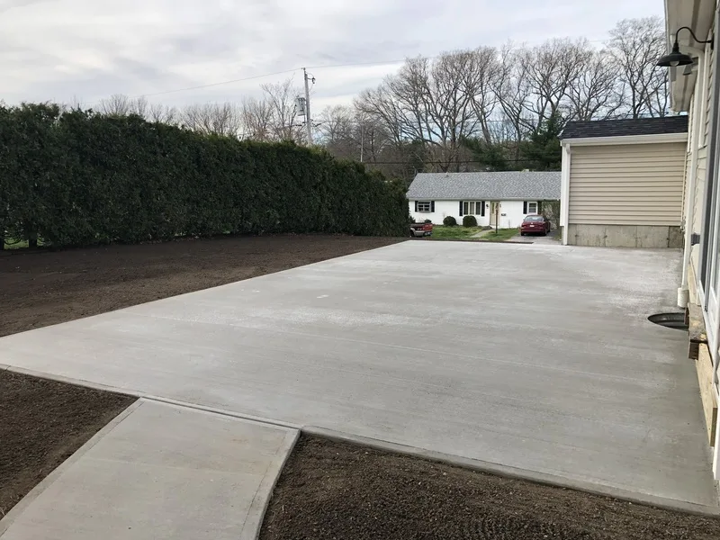 Broad concrete driveway apron with a walkway