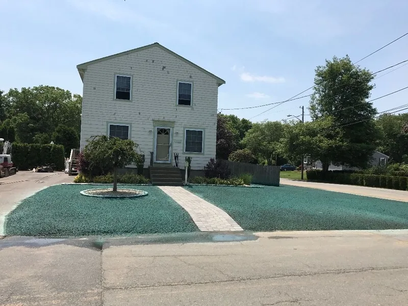 Hydroseeded lawn and walkway in front of a two-story home