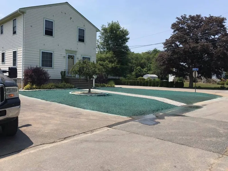 Green hydroseed lawn with a curved path and small tree