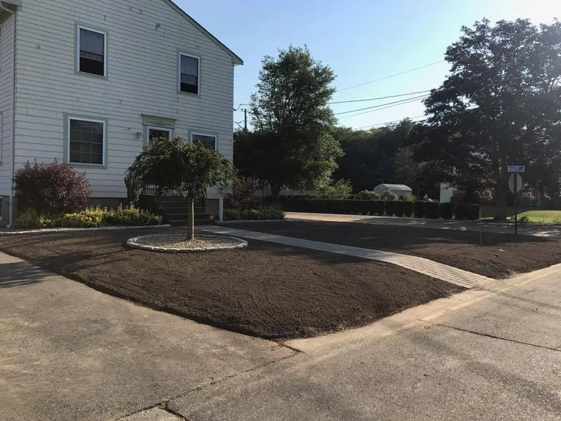 Freshly graded loam ready for seeding in front of a home