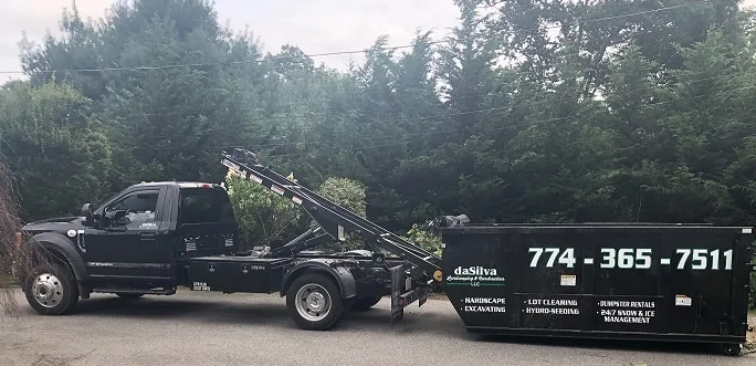 daSilva Landscaping roll-off truck with the phone number 774-365-7511 on the container