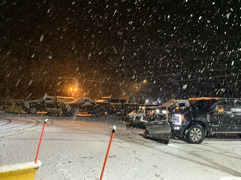 Plow trucks working a lot during an evening snowfall